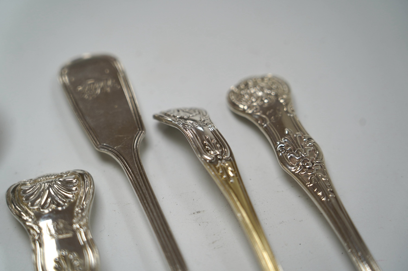 A pair of George IV silver King's pattern sauce ladles, by William Eaton, London, 1824, 17.5cm, two Victorian silver butter knives and a Victorian silver condiment spoon, 13.7cm, 10.5oz. Condition - fair to good